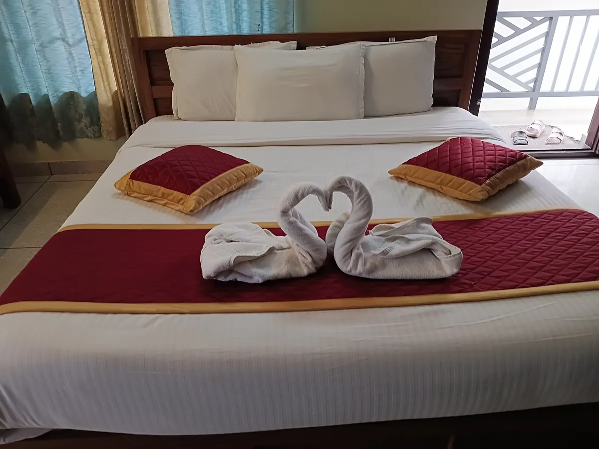 Pleasant Holiday Resort bedroom with towel decor